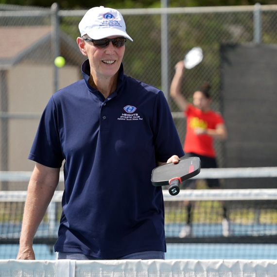 John playing pickleball.