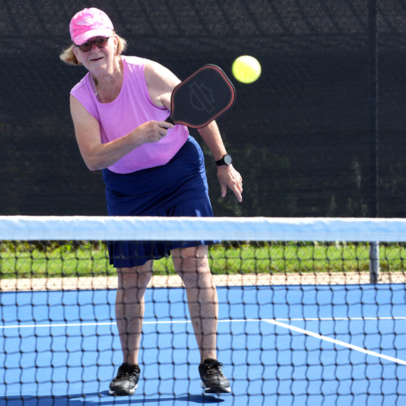 Playing pickleball.